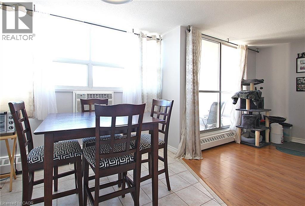 A dining room with a table and chairs.