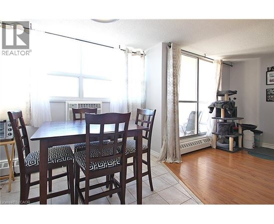 A dining room with a table and chairs.