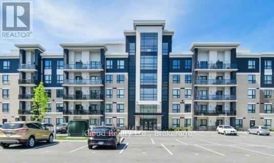 A large apartment building with a parking lot in front.