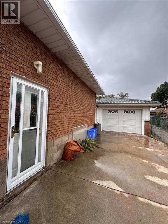 A house with a white door and a garage door is shown.