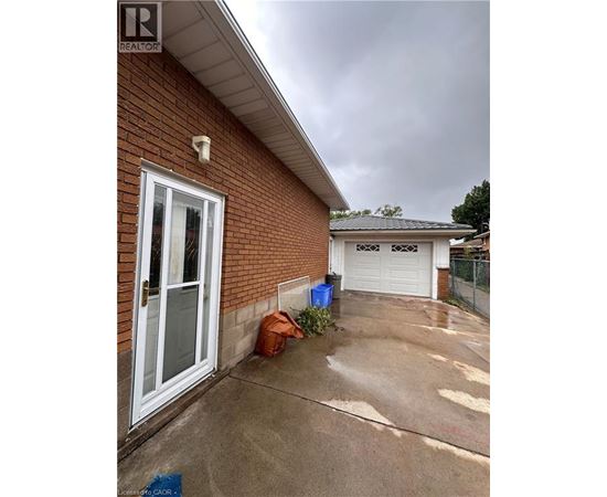 A house with a white door and a garage door is shown.
