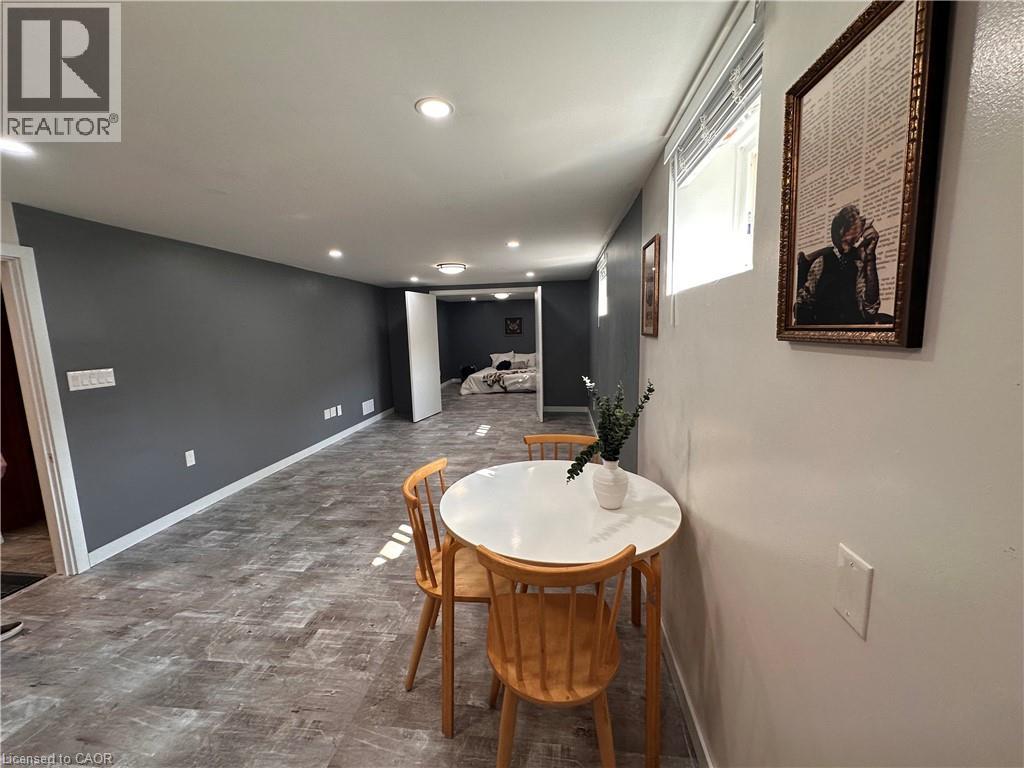 A dining room with a white table and chairs.