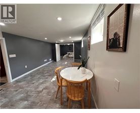 A dining room with a white table and chairs.