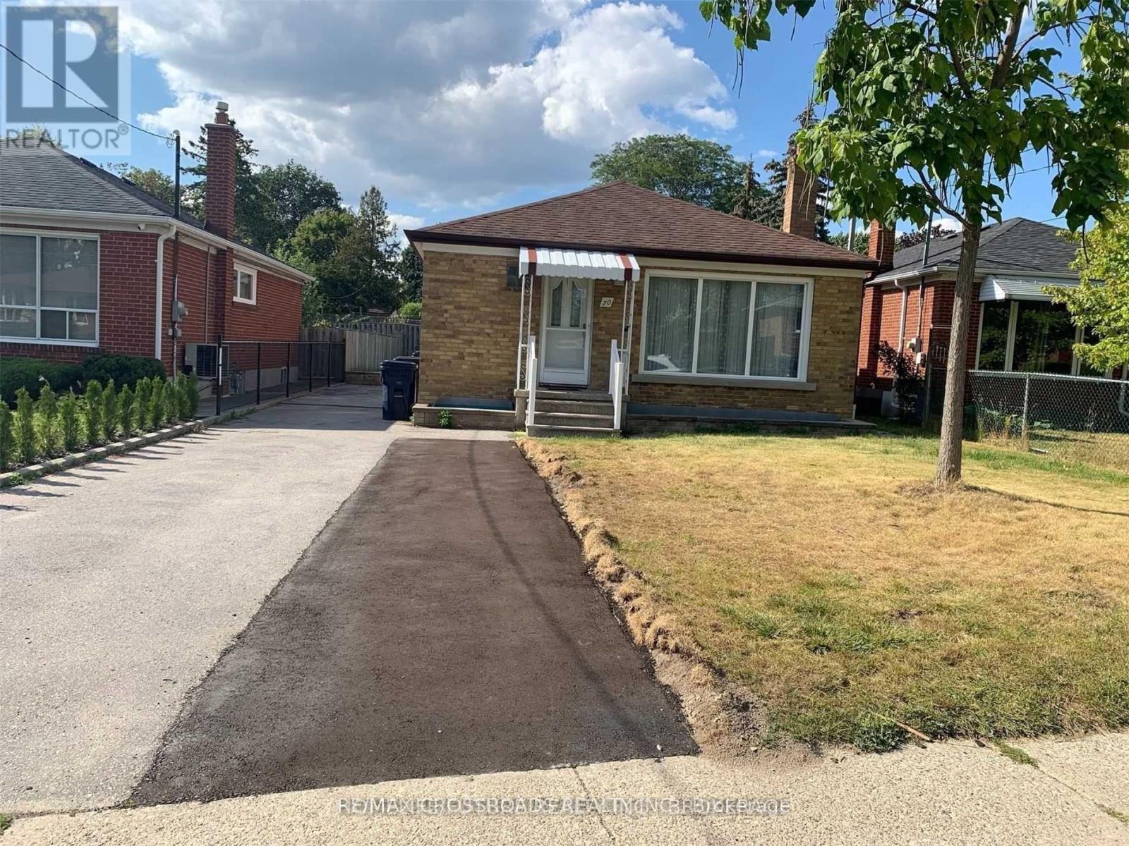 A house with a driveway in front of it.