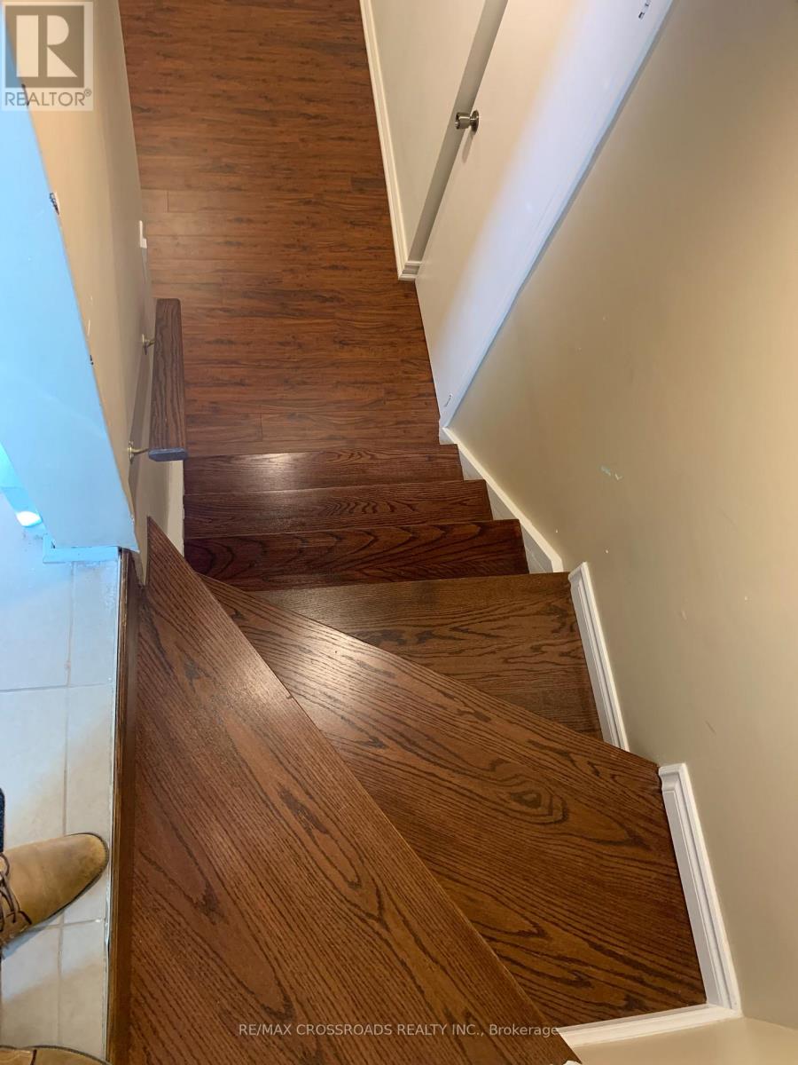 A wooden staircase with a white railing.
