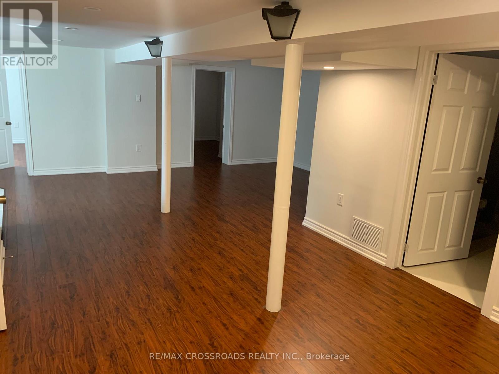 A room with wooden floors and white walls.