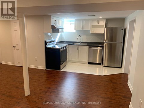 A kitchen with white cabinets and a black countertop.