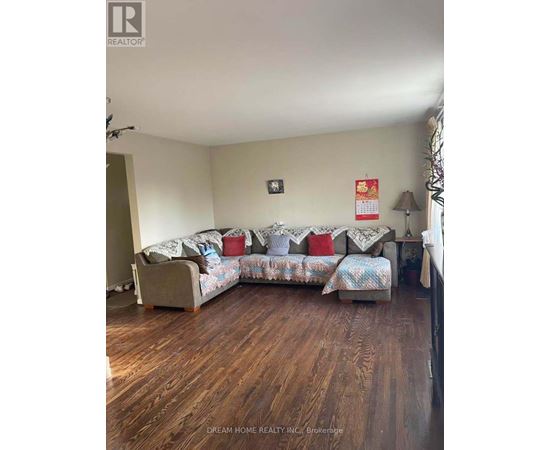 A living room with a couch and a lamp.