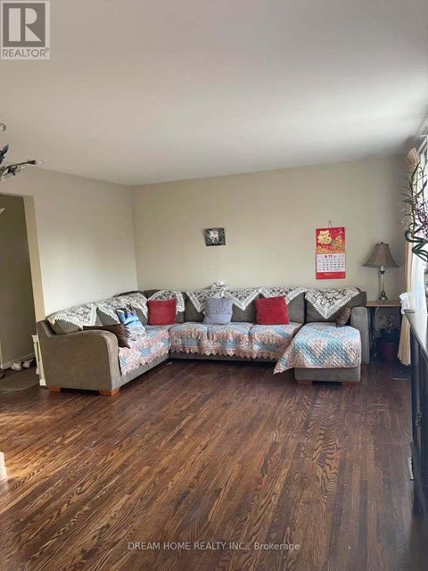 A living room with a couch and a lamp.