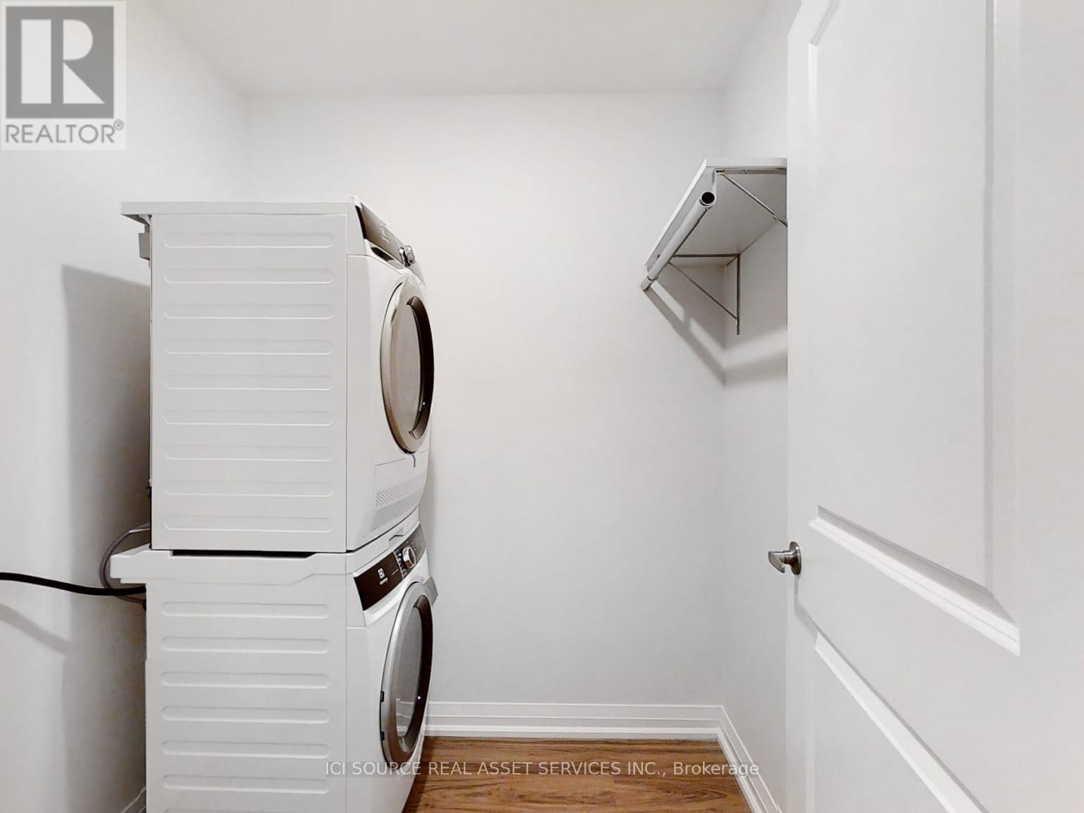 A white washing machine and dryer in a small laundry room.