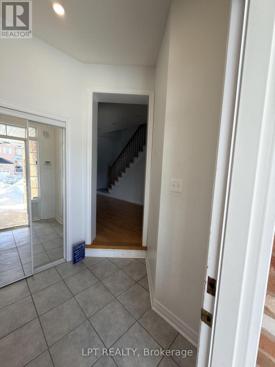 A hallway with a staircase leading to the second floor.