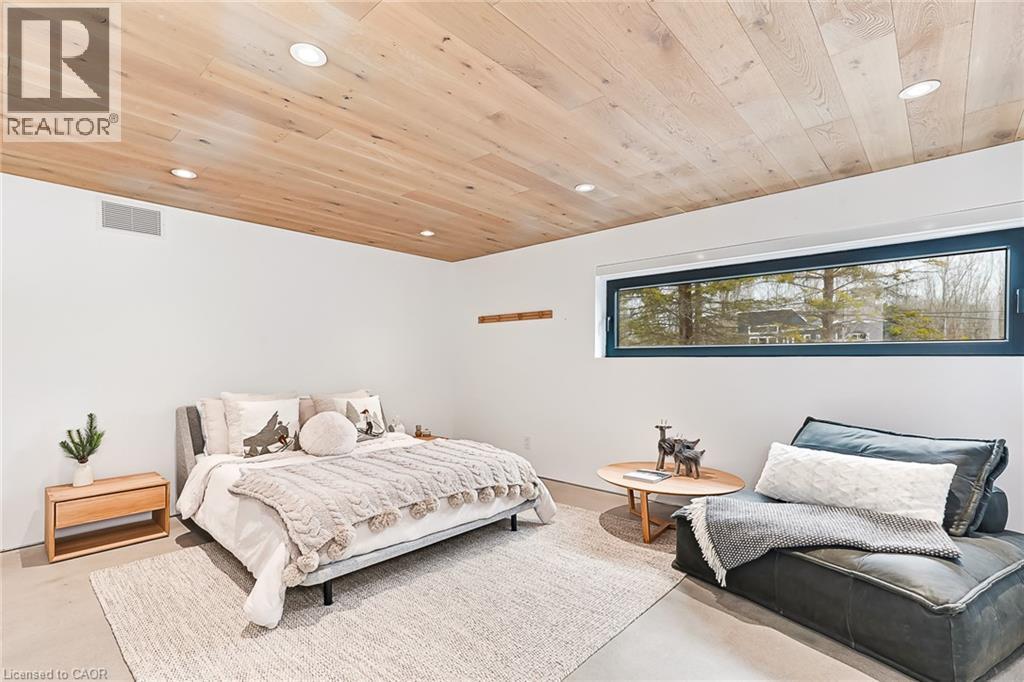 A bedroom with a large bed and a couch.