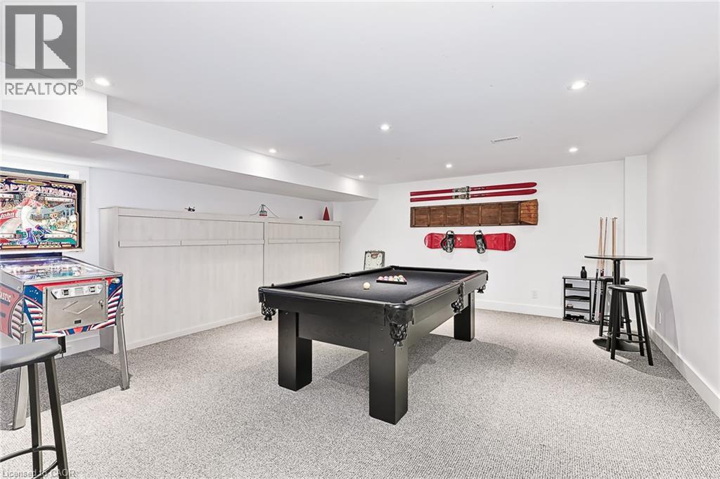 A pool table is in the middle of the room.