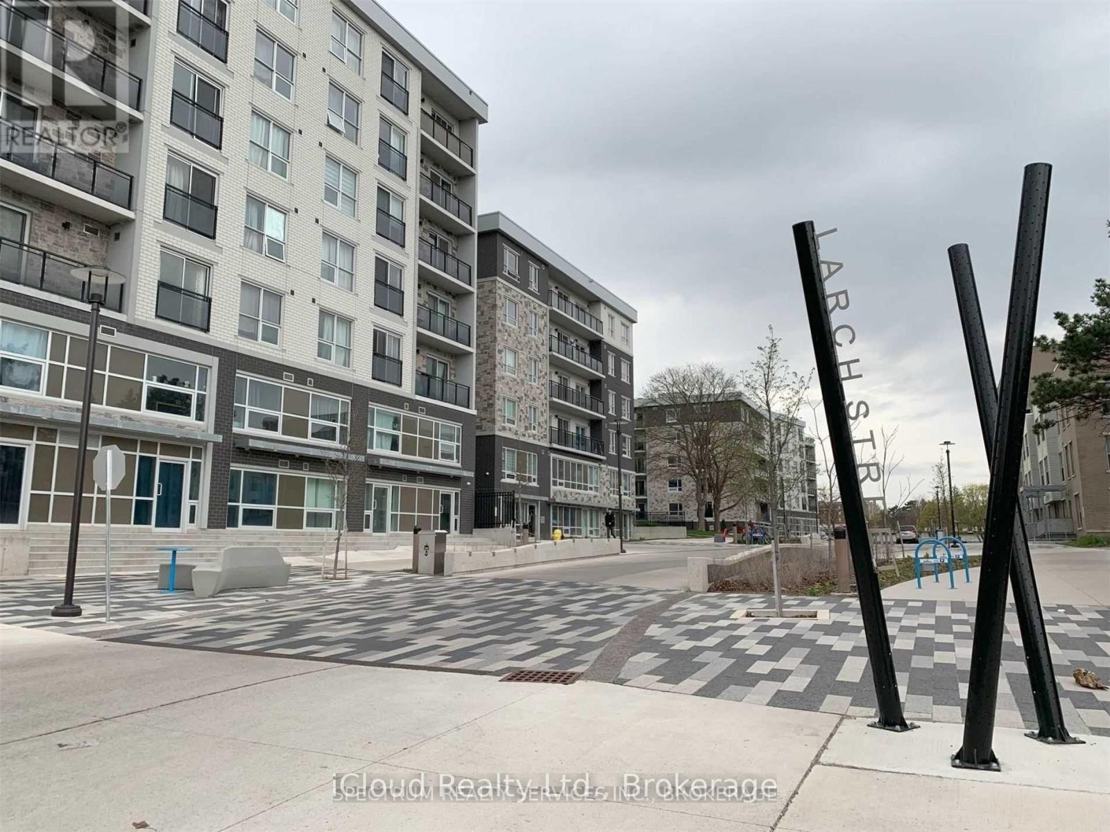 A view of a street with apartment buildings and a playground.