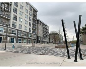 A view of a street with apartment buildings and a playground.