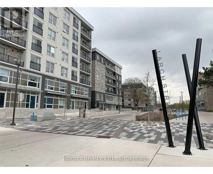A view of a street with apartment buildings and a playground.