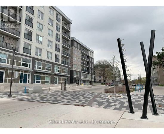 A view of a street with apartment buildings and a playground.