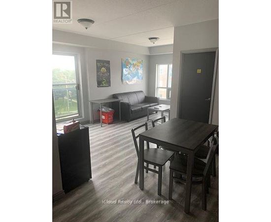 A living room with a couch, a table and chairs.