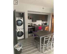 A modern kitchen with a table and chairs.