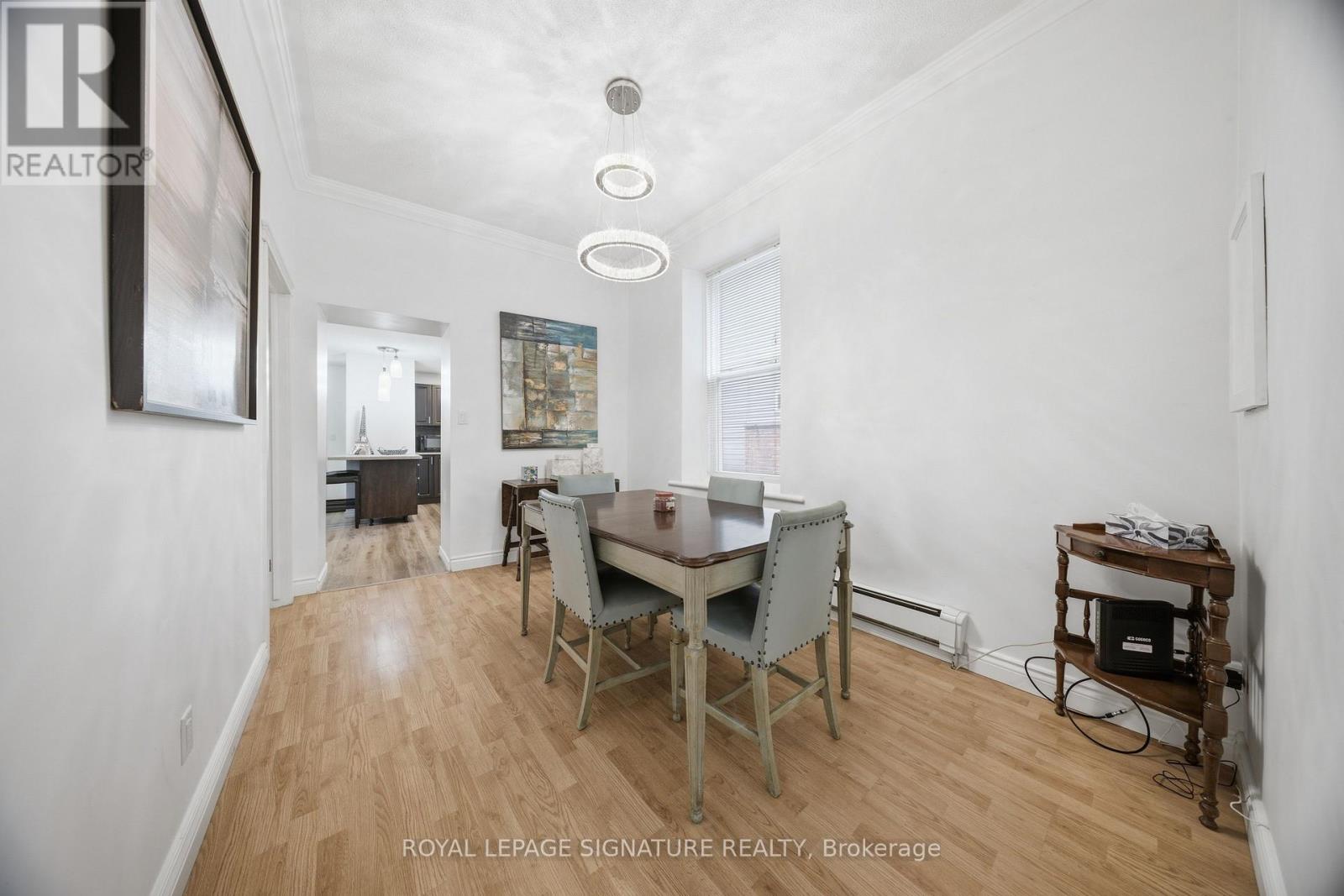 A dining room with a table and chairs.