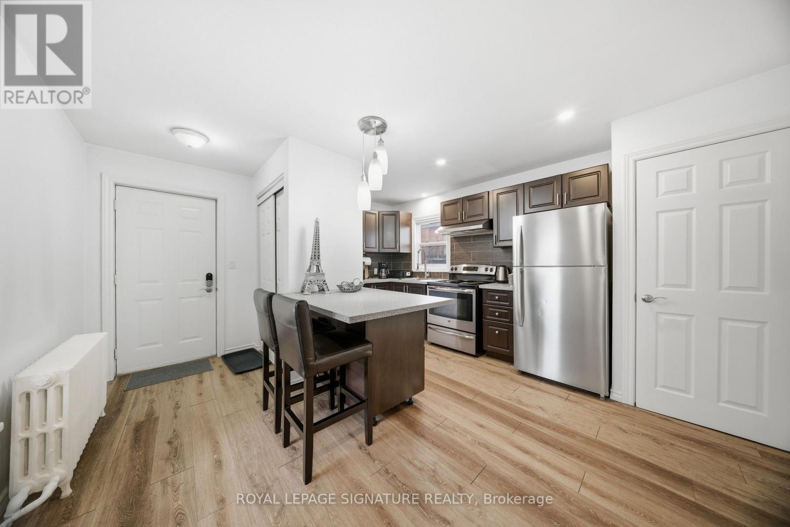 A well-lit kitchen with a dining table and chairs.