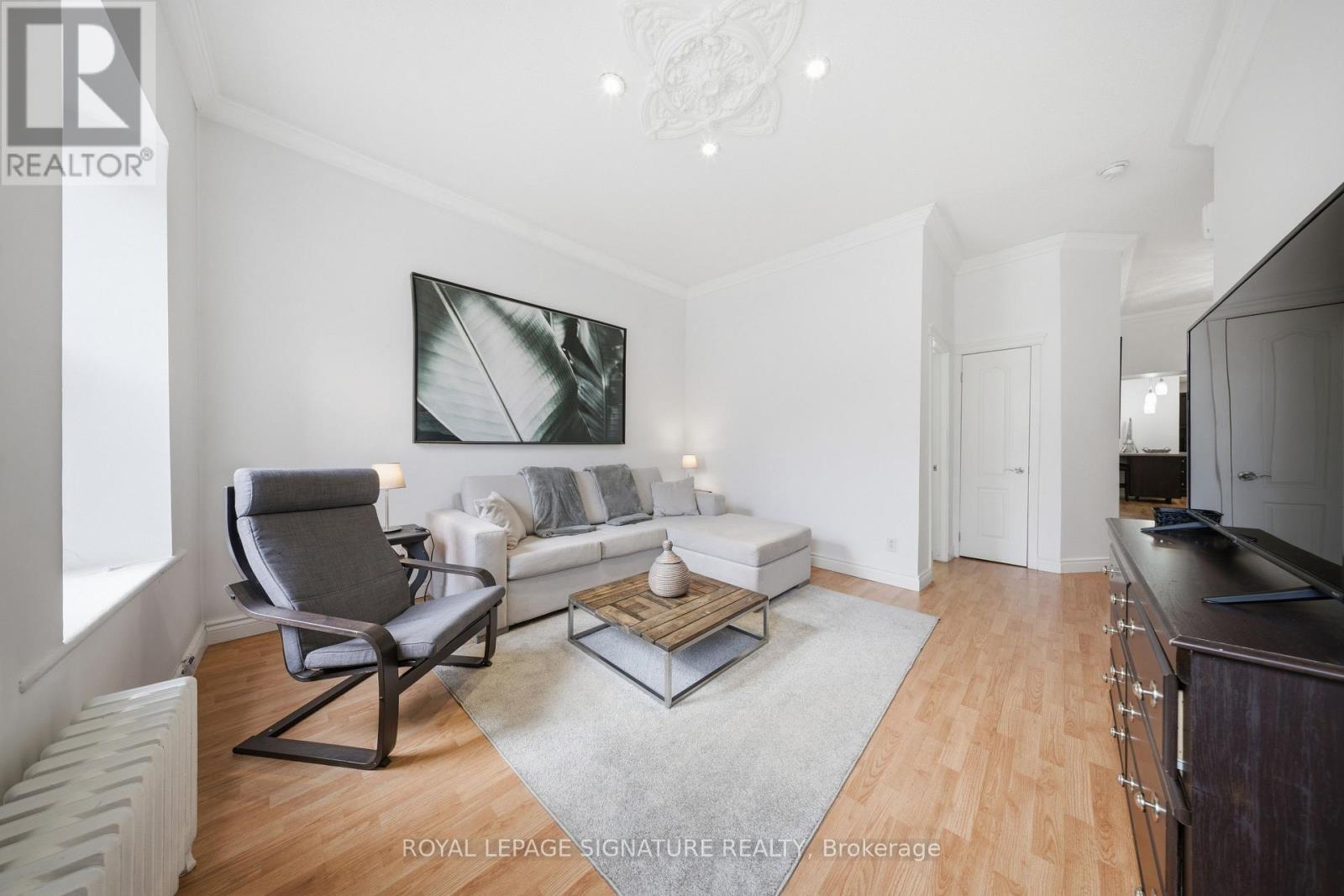 A living room with a grey chair and a white couch.