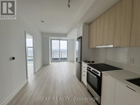 A kitchen with white cabinets and a black stove top oven.