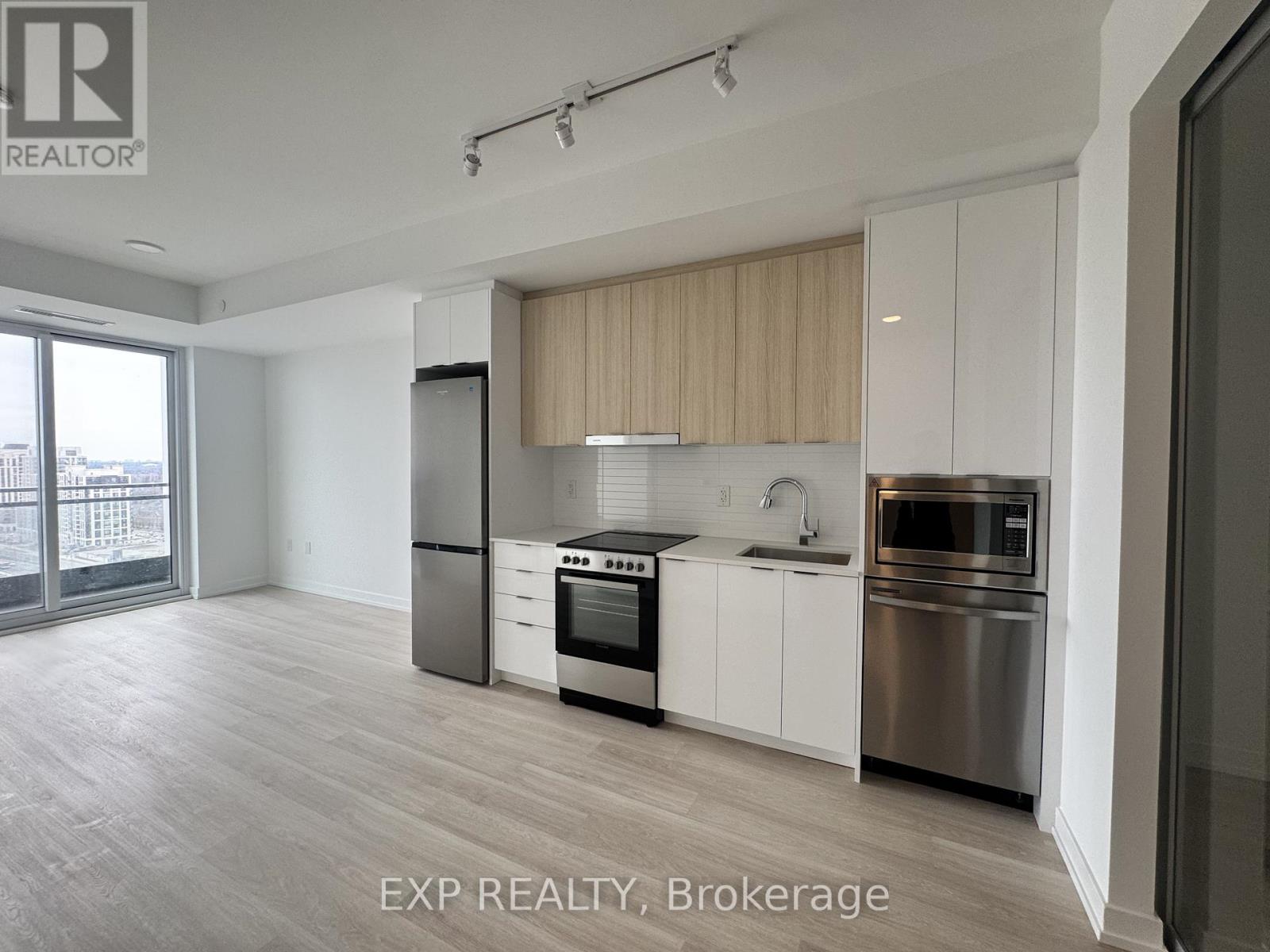 A kitchen with white cabinets and stainless steel appliances.