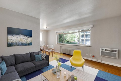 a living room with a couch and a yellow chair