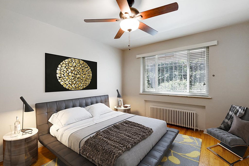 a bedroom with a bed and a ceiling fan