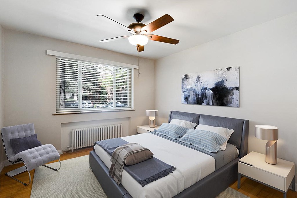 a bedroom with a bed and a ceiling fan