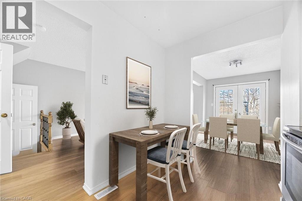 A dining room with a wooden table and chairs.