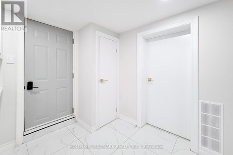 A white room with a door, a wall, and a floor.