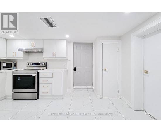 A white kitchen with a stainless steel oven and white cabinets.