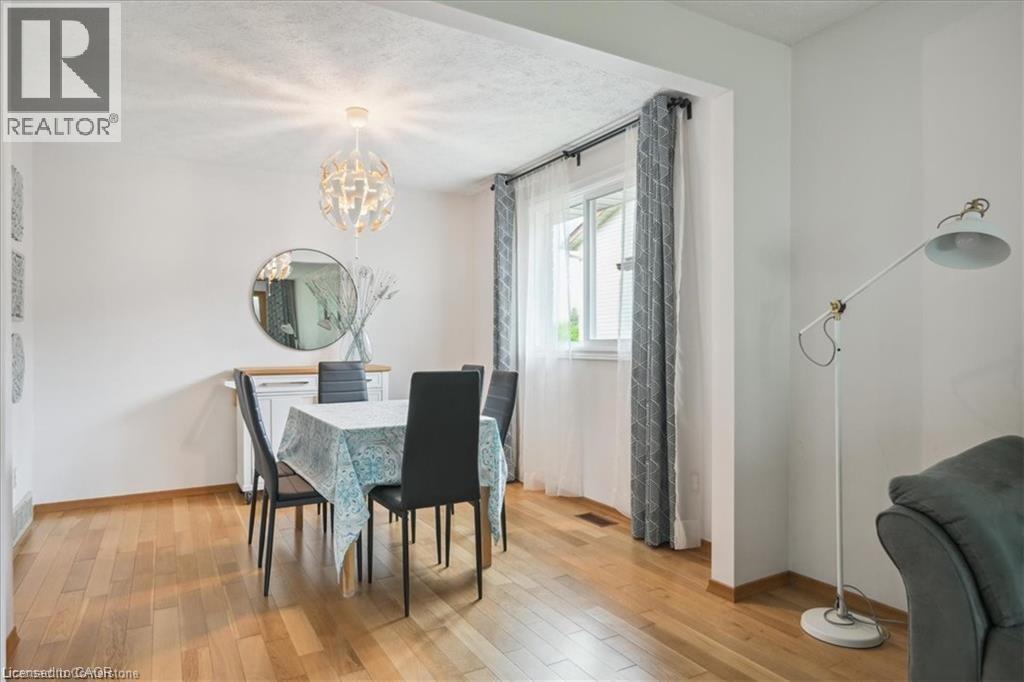 A dining room with a table set for four.