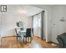 A dining room with a table set for four.