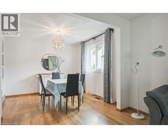 A dining room with a table set for four.