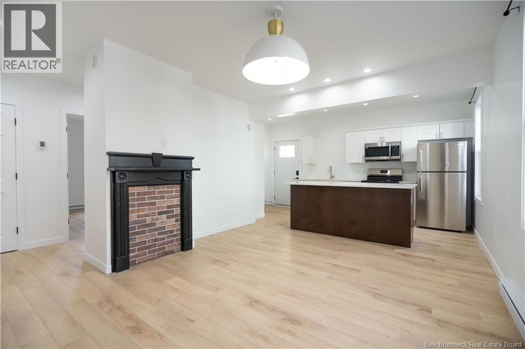 A modern living room with a fireplace and wooden floors.