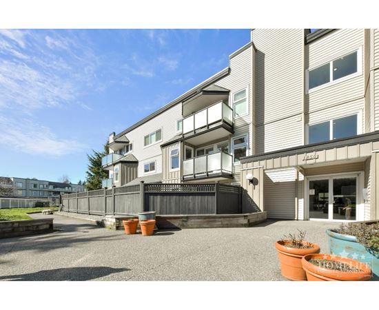 A building with a balcony and a sign that says "Apartments".