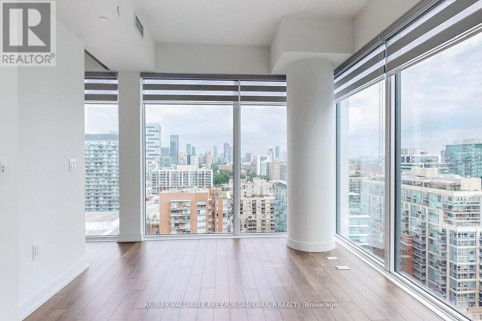 A spacious room with a view of the city skyline.