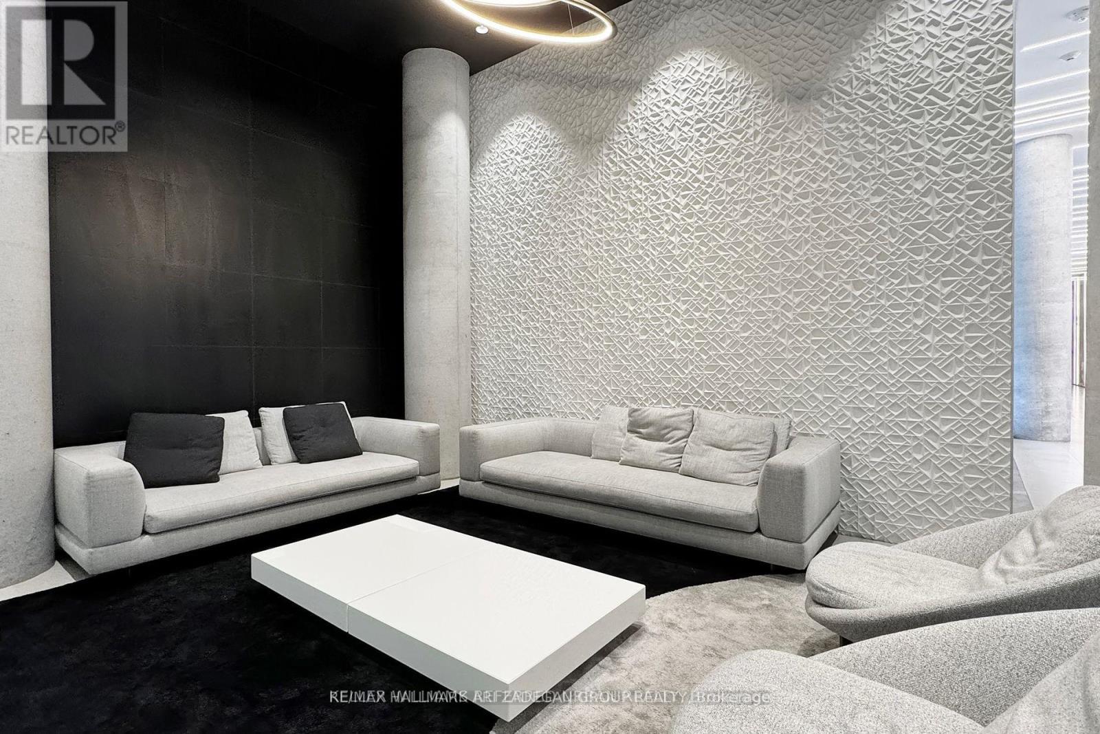 A modern living room with a white sofa and a white coffee table.