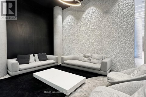A modern living room with a white sofa and a white coffee table.