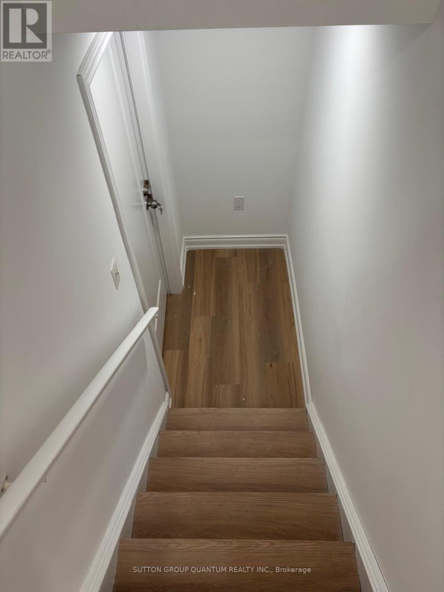 A staircase with wooden steps and white walls.