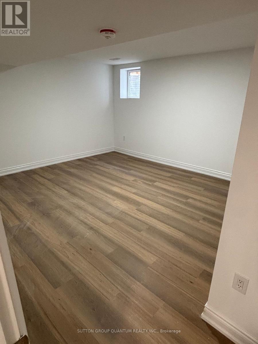 A room with wooden flooring and a window.