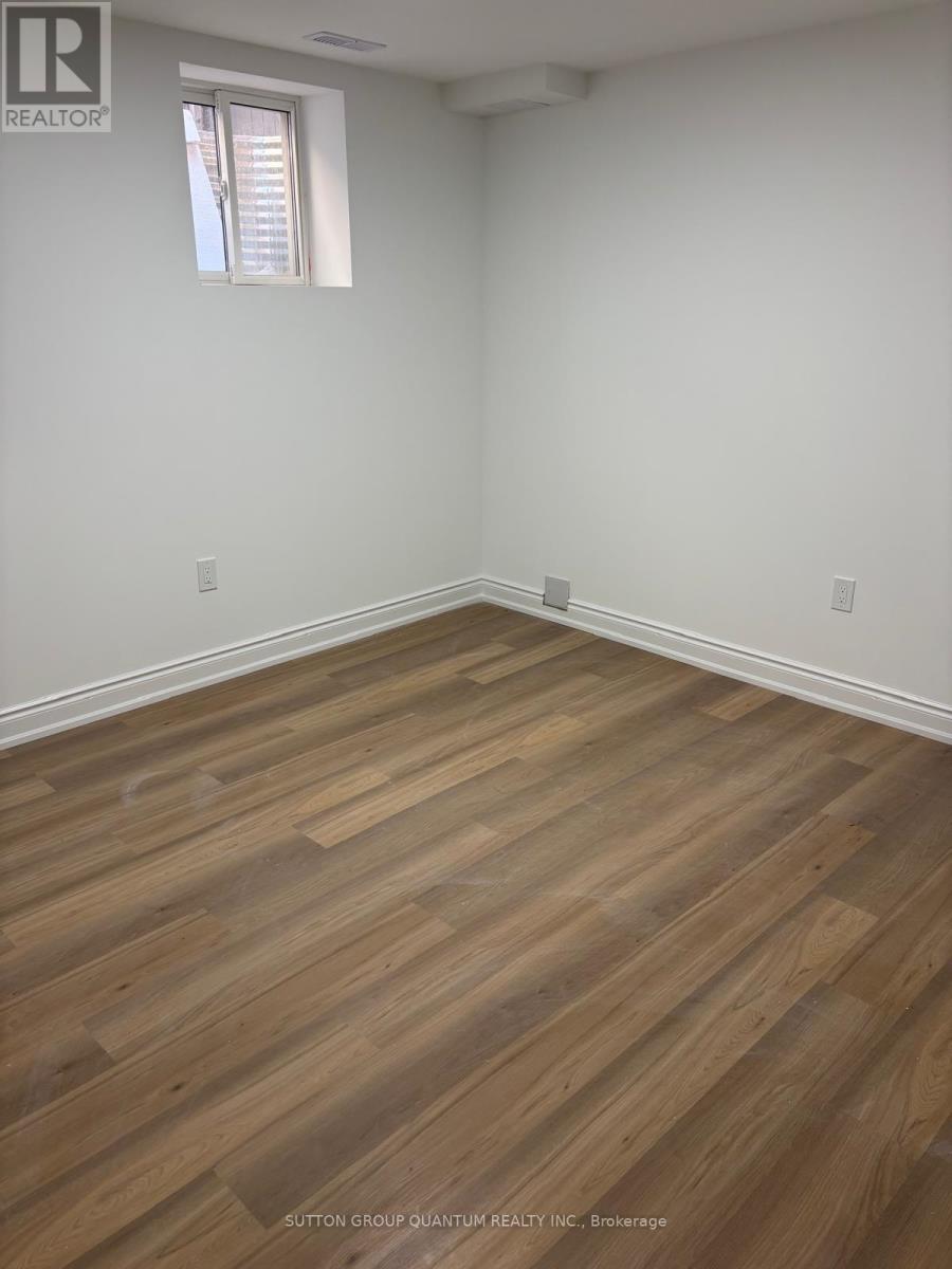 A room with wooden flooring and a window.