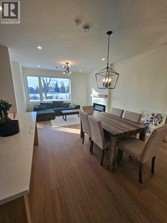 A modern dining room with a wooden table and chairs.