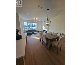 A modern dining room with a wooden table and chairs.