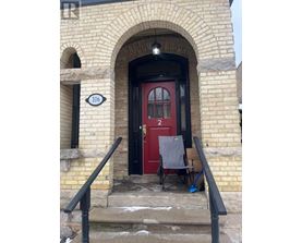 A red door with a sign that says 106 on the left.