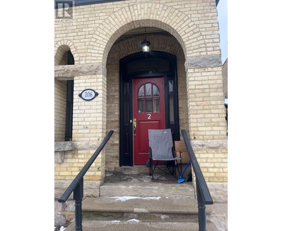 A red door with a sign that says 106 on the left.