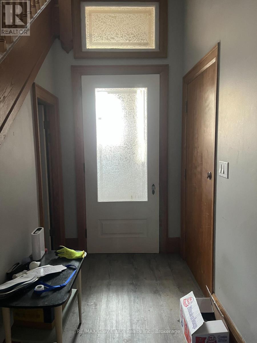A room with a table and a box on the floor.